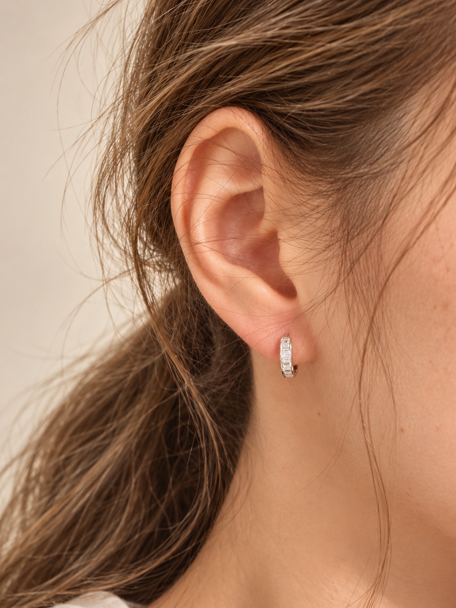 Baguette zirconia hoop earrings worn on the ear